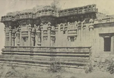 Another view of the same carved Hindu temple, its walls and moulded plinth.