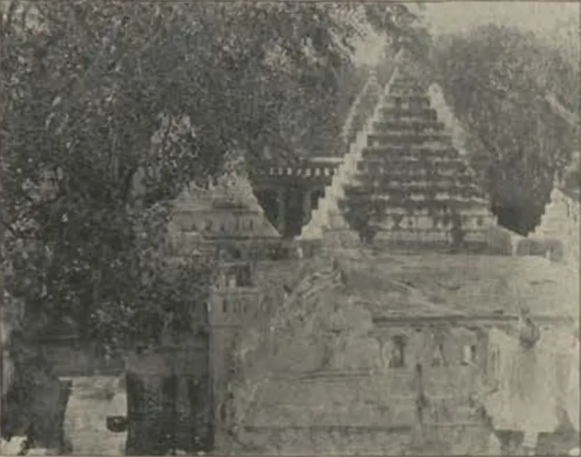 Temple towers with stepped pyramidal roofs behind a wall, among trees.