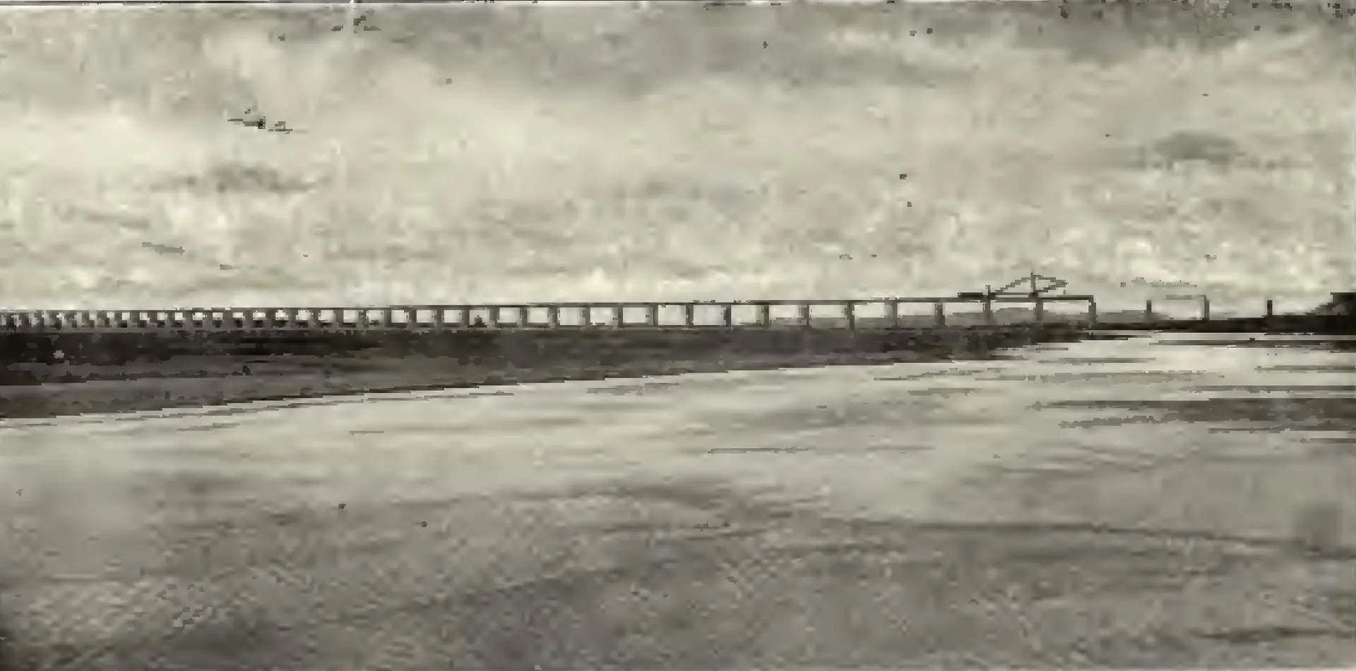 A long railway bridge with many spans crossing the wide Godavari river.