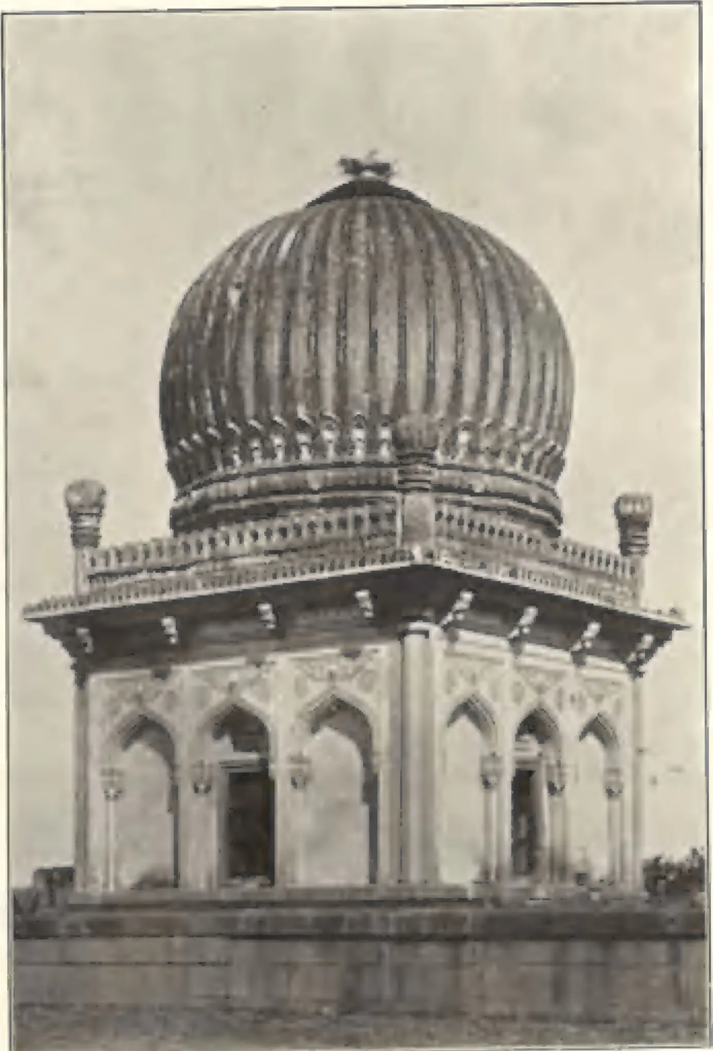 A small square tomb with a ribbed dome and corner turrets, near the tomb of Sultan Quli Qutb Shah.