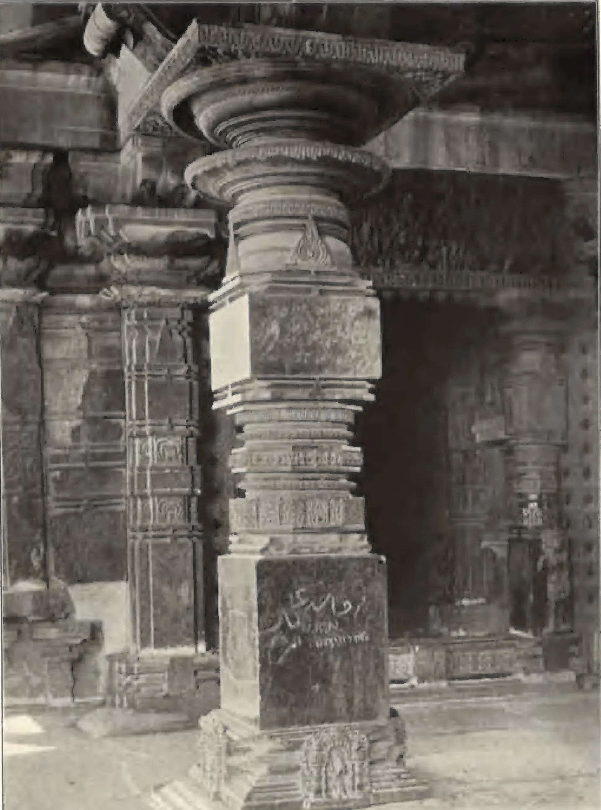 A carved pillar of the Thousand Pillar Temple, with an inscription on its square base.