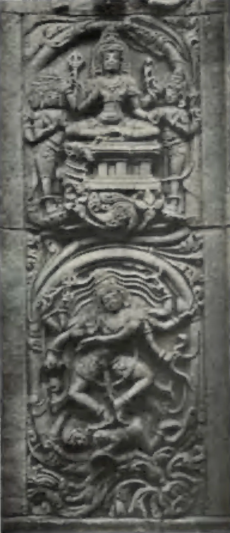 A carved stone panel with a seated deity above and a dancing figure below, from the Panchesvara temple at Panagal.