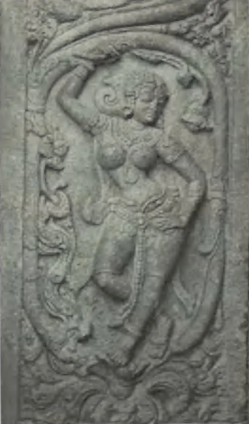A carved panel of a dancing woman under a scroll of foliage, from the Panchesvara temple at Panagal.