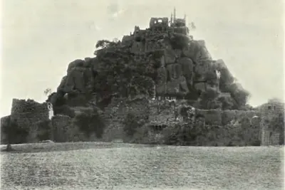 The old fort at Elgandal on a rocky hill, with walls at its foot.