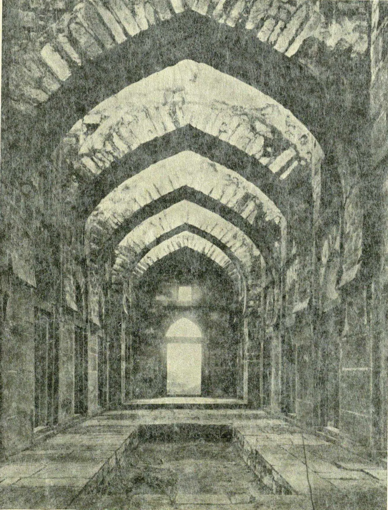 The interior of Shitab Khan's hall, a long passage under a row of pointed arches.