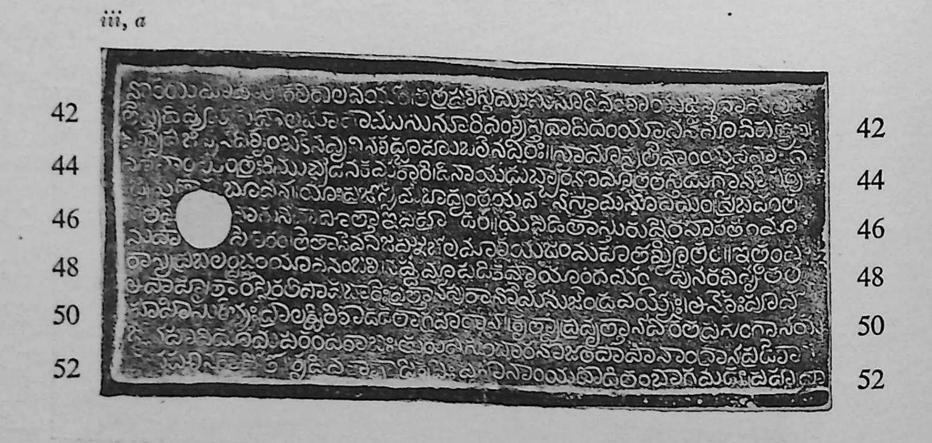 Ink impression of the first side of the third copper plate, white Telugu letters on black inside a raised rim, a round ring hole at the left, line numbers 42 to 52 in the margins.