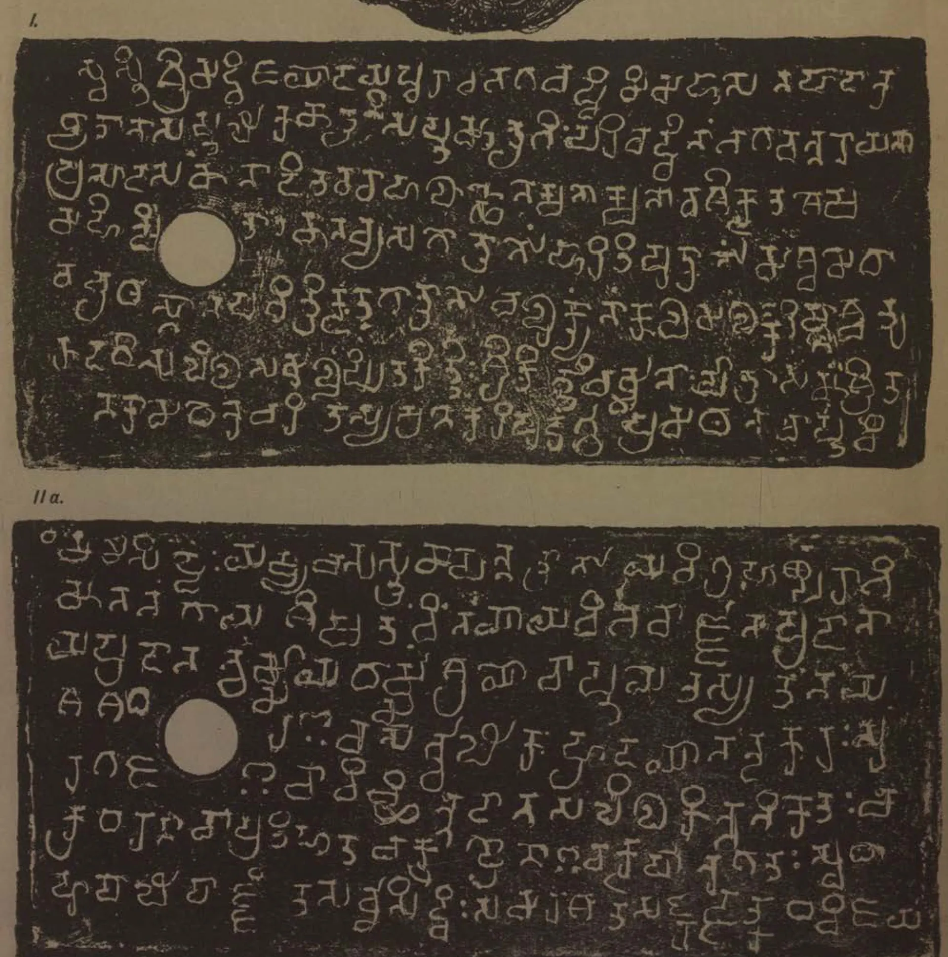 Ink impressions of two inscribed copper plates, the letters of the Telugu-Kannada script showing pale on a dark ground, each plate with a round ring hole near the left edge.