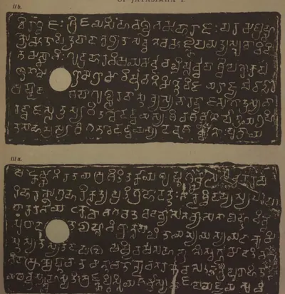 Ink impressions of two inscribed copper plates, the letters of the Telugu-Kannada script showing pale on a dark ground, each plate with a round ring hole near the left edge.