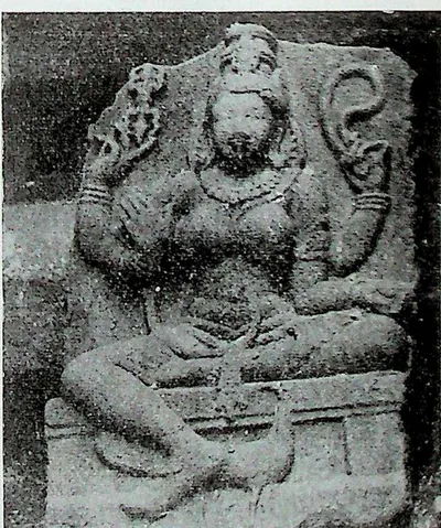 A seated goddess identified as Kaumari, with several arms and a tall crown, carved in high relief on a stone slab; a peacock below her.