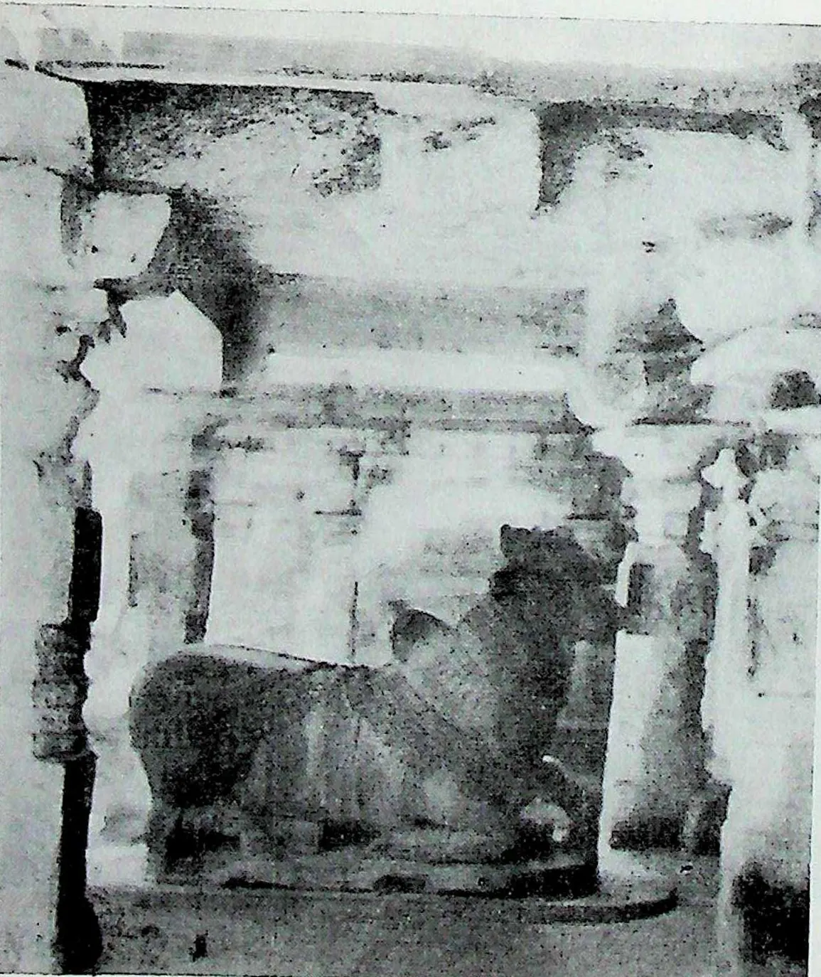 A large seated bull, Nandi, inside a pillared pavilion, seen through the front columns.