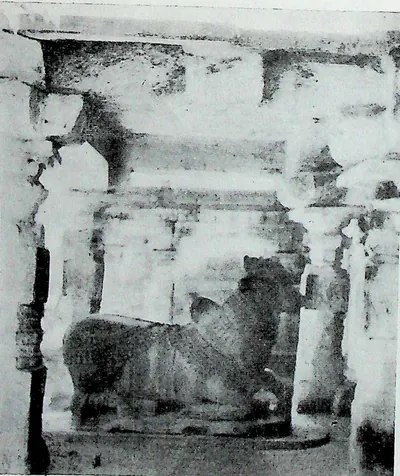 A large seated bull, Nandi, inside a pillared pavilion, seen through the front columns.