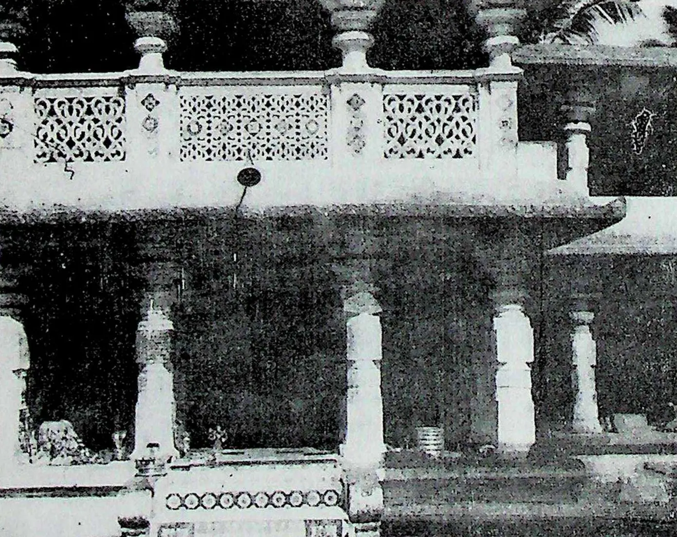 A pillared verandah with a balustrade of pierced stone screens above, in front of the shrine of the goddess Manikyamba.