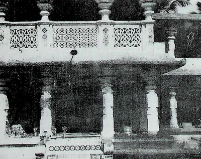 A pillared verandah with a balustrade of pierced stone screens above, in front of the shrine of the goddess Manikyamba.