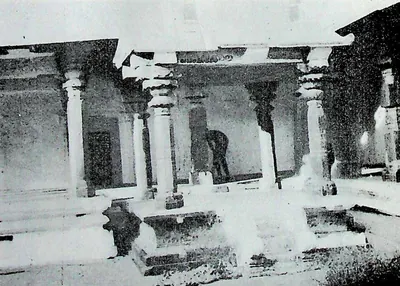 A pillared hall in the north-east corner of the enclosure at Chalukya Bhimavaram (Samalkot), with stepped platforms and a person seated on the steps.