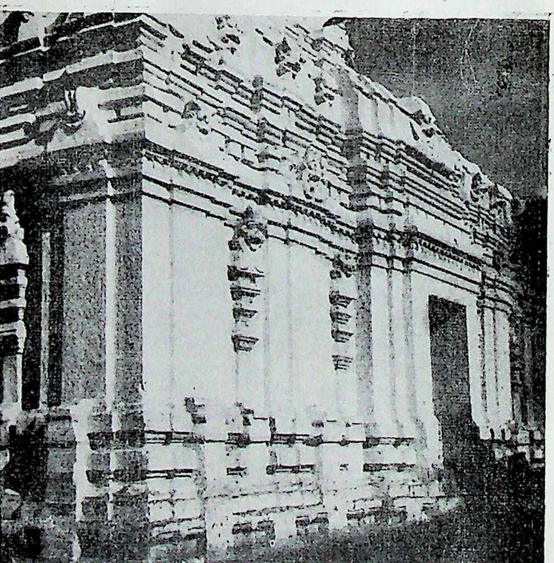 The east and north walls of a temple, seen at the corner: plastered walls with pilasters, niches and heavy cornices.