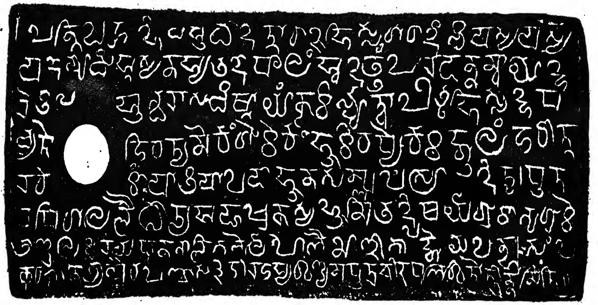 Lithograph of one copper-plate face, white letters on black: eight lines of Kalinga-script letters with a white ring-hole at the left.