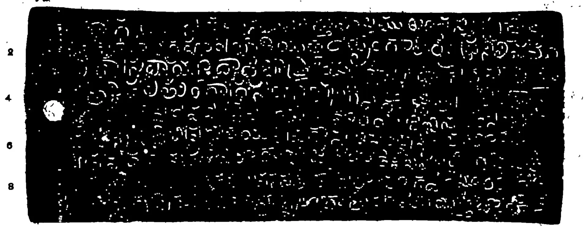 Photo-lithograph of a long copper-plate face, white Telugu letters on black in nine lines, with a ring-hole at the left and line numbers 2 to 8 in the margin.