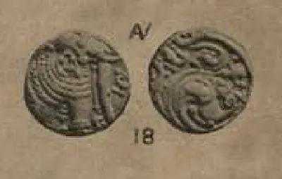 Photograph of the two sides of a small gold coin: a standing elephant on one, a dense scroll pattern on the other, with the plate number 18 below.