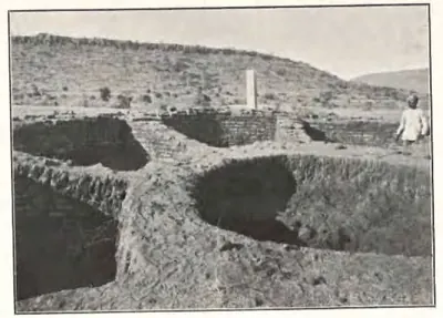 Trenches cut into the stupa mound, showing the curved brick walls of its wheel-shaped foundation.
