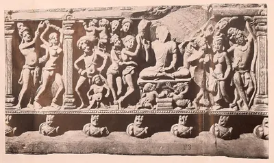 Carved frieze panel with a seated Buddha among standing figures.