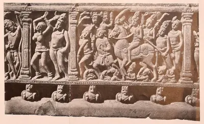 Carved frieze panel with a prince riding a horse in a crowd.
