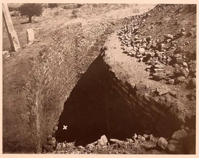 A deep cutting into the brick body of the Great Stupa, with a cross marking where the relics lay.