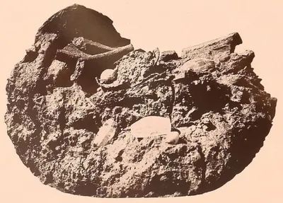 A lump of earth and broken brick with the relic deposit as it was found.