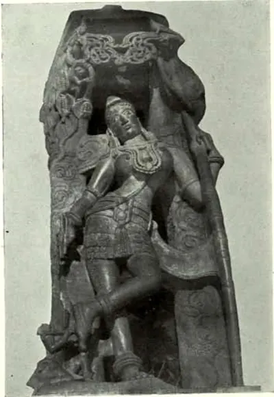 A stone bracket carved with a crowned, jewelled figure in a pleated skirt standing cross-legged beside a long bow, under a carved creeper; shown cut out against a plain background.