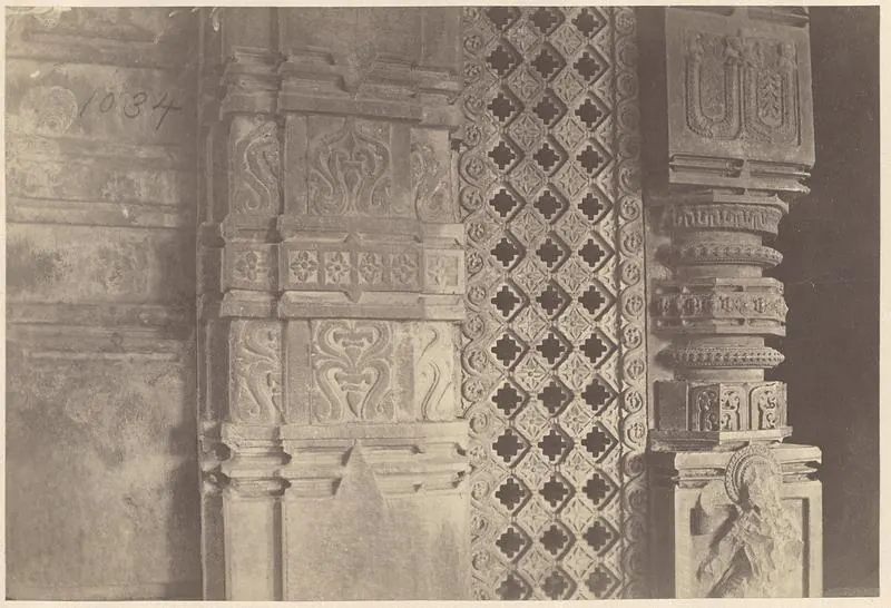 Close view of a carved door jamb, a pierced stone screen with a lattice pattern and a carved pillar; the number 1034 is written on the print.
