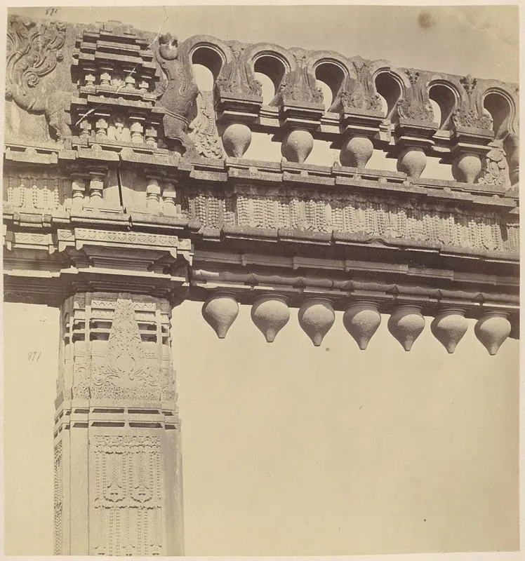 The upper part of a carved stone gateway seen from below: a pillar, a bracket with a rearing animal and a crossbeam with arched niches, a stone swan and hanging stone buds.