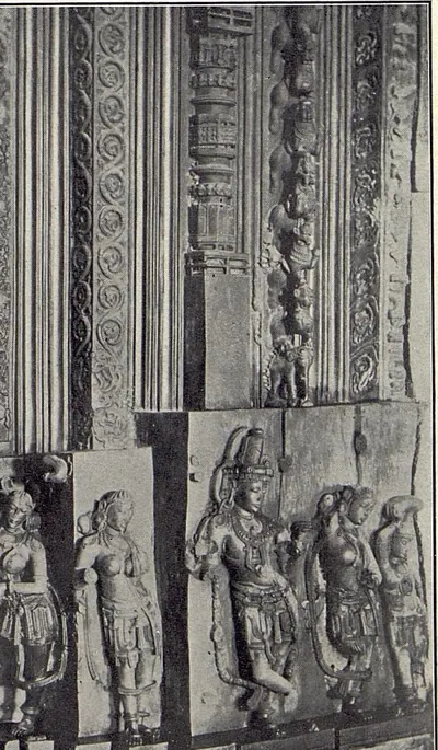 Part of a carved door jamb: vertical bands of scrollwork above a row of standing figures in relief.