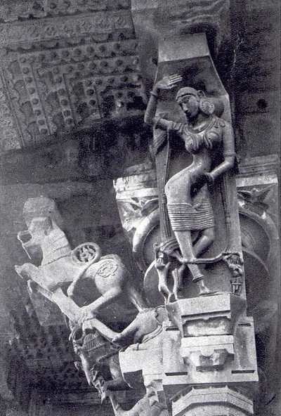 A slanting stone bracket carved with a standing woman, set above a pillar capital under the ceiling, with a rearing animal bracket beside it on the left.