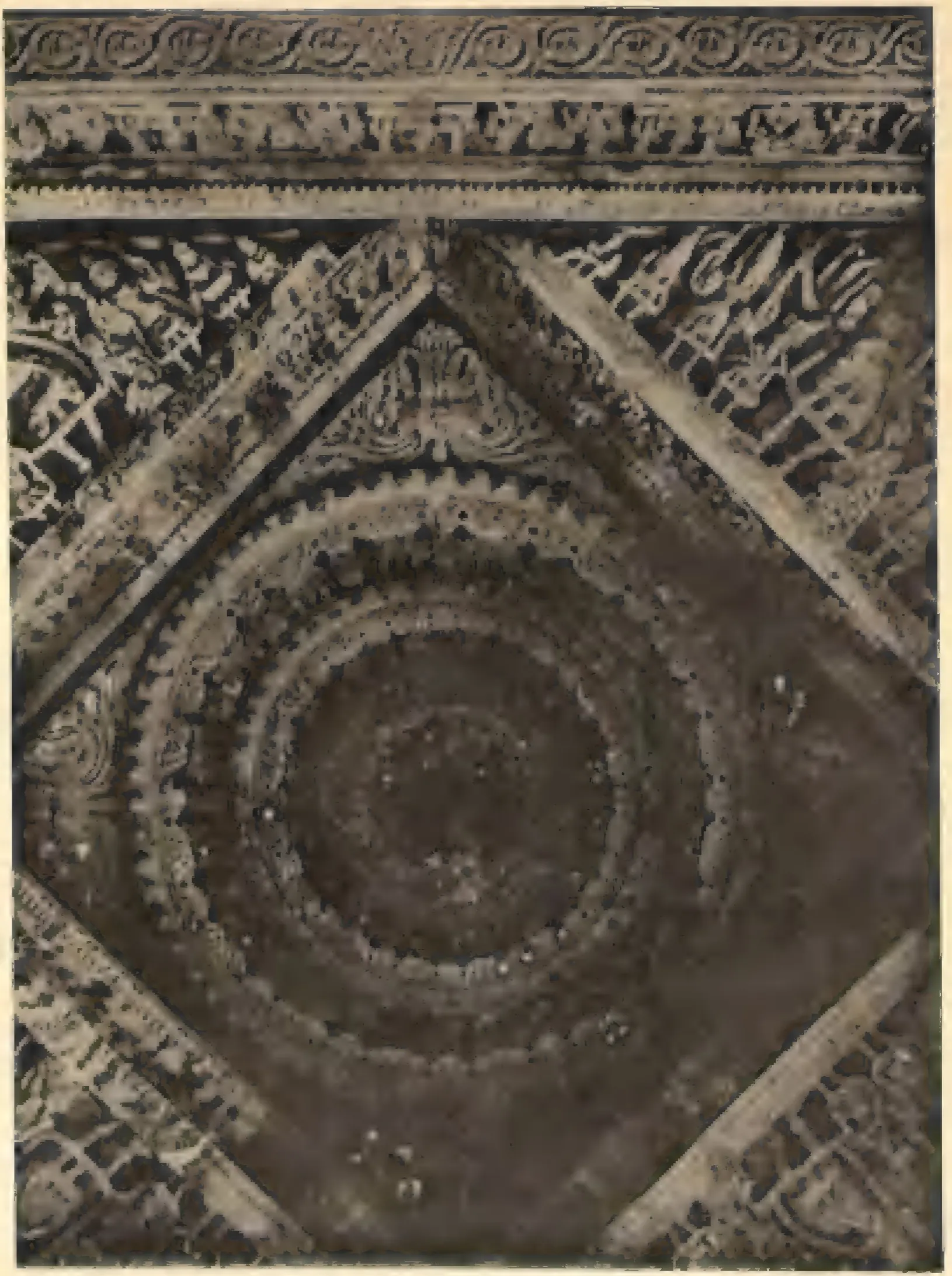 A carved stone ceiling panel of the southern temple at Nagulapadu: a deep circular lotus of concentric rings set in a square turned diagonally, framed by bands of figures and foliage.
