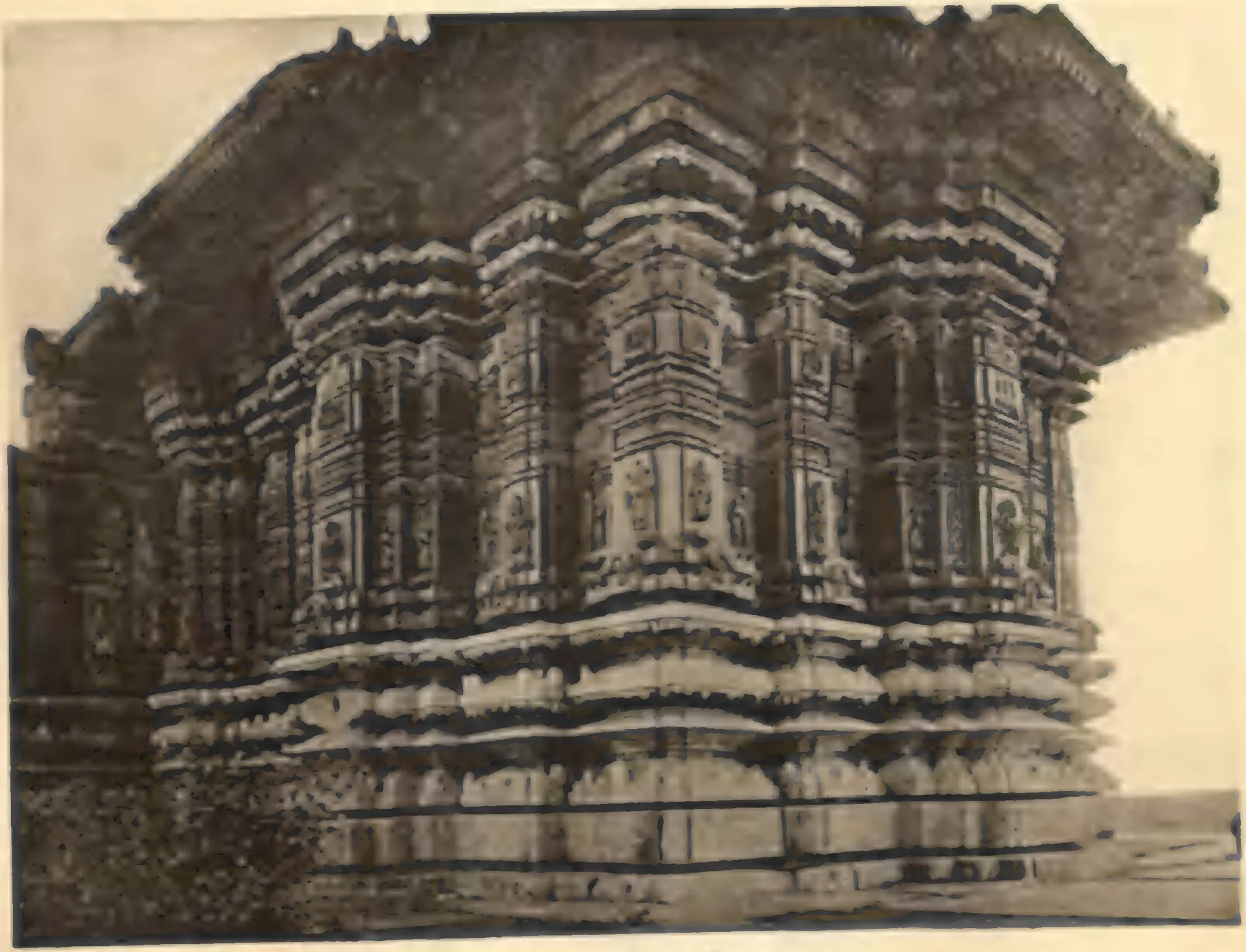 Close view of the outer wall of the shrine of the northern temple at Nagulapadu, densely carved in projecting pilasters, small figures and horizontal mouldings under a deep eave.