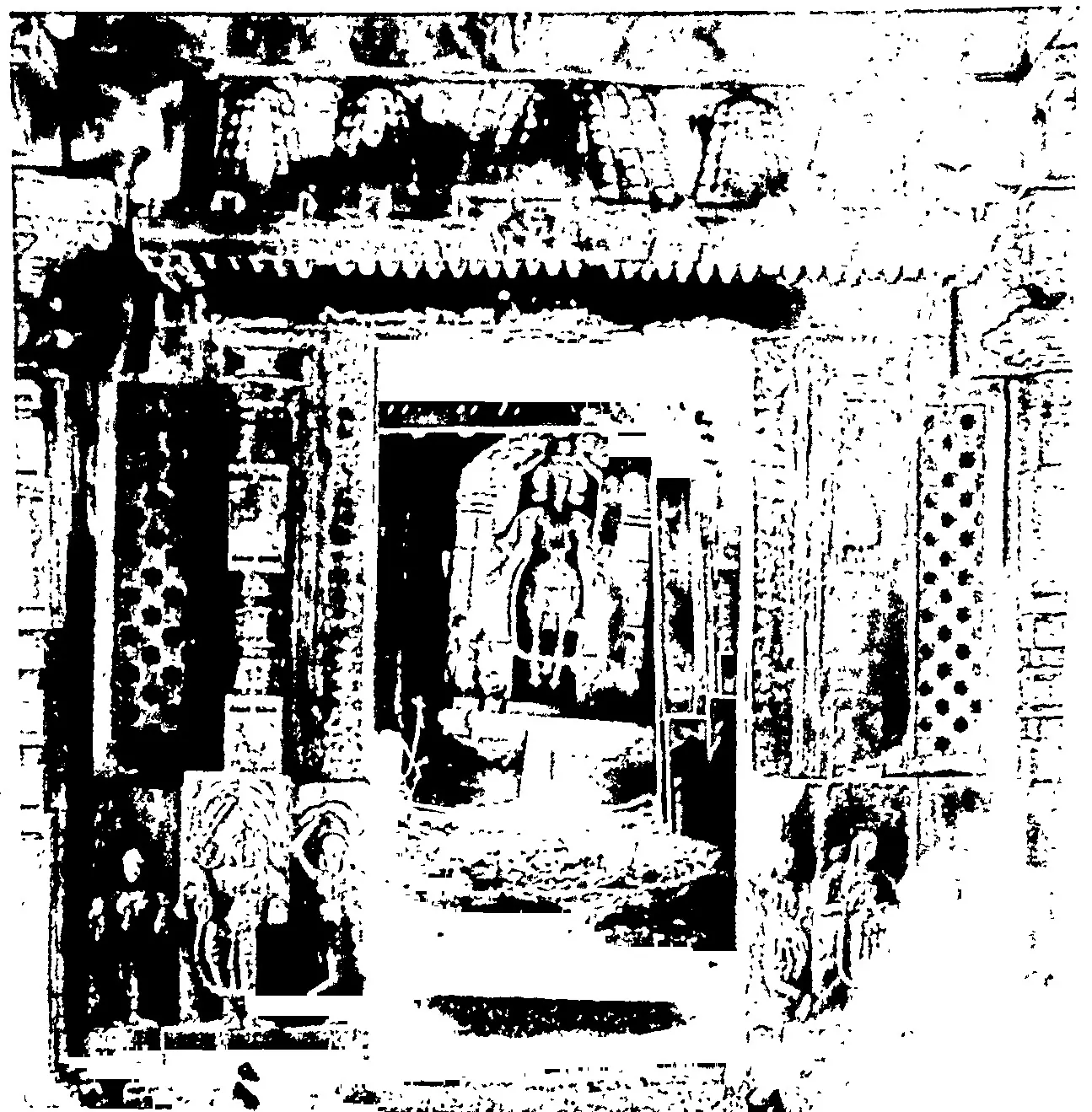 A carved shrine doorway of a Katakshapur temple, with pierced screens and figures on the jambs and a standing Vishnu image inside the shrine; high-contrast black-and-white reproduction.