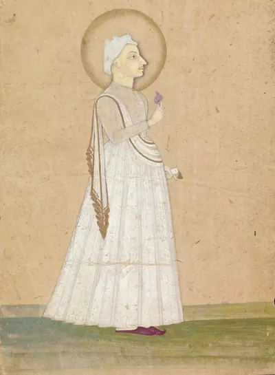 Indian painting of a slender young man in a long white robe and white turban, with a halo, standing in profile and holding a flower, against a buff ground with a strip of green below.