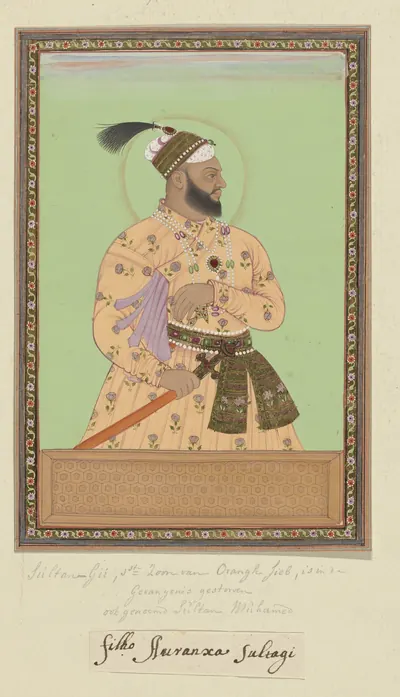 Deccani painting of a bearded man in a patterned orange robe and plumed turban, standing in profile with a halo against a green ground, in a decorated border with handwritten notes below.