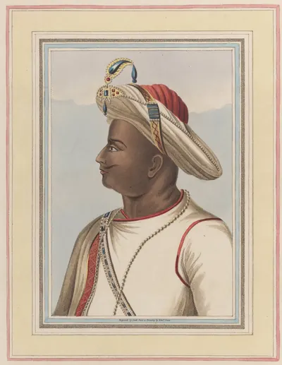 Hand-coloured engraving of a man in profile in a white robe and a large striped turban with a jewel, within a ruled border.