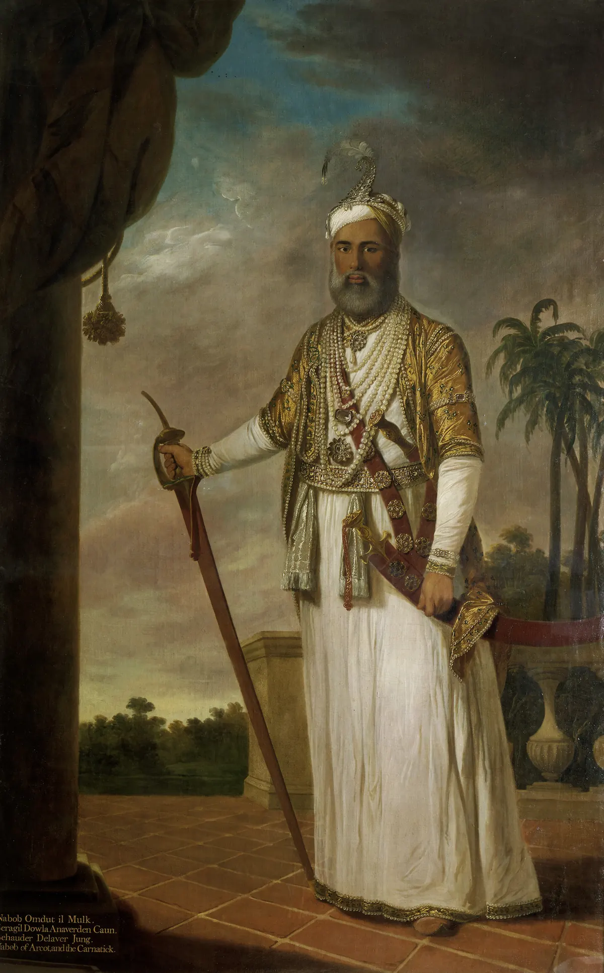 Painting of a white-bearded man standing full length in a white robe and turban, with a gold-embroidered sash and a sword, beside a column with palm trees behind him.