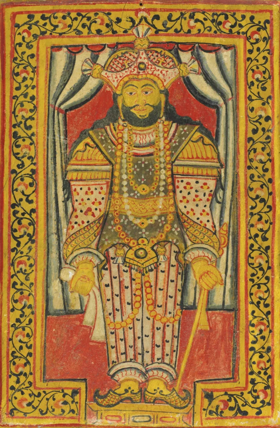 A bright painting in red and yellow of a bearded king standing under a curtain, wearing a tall crown, long necklaces and a patterned robe, holding a staff, inside a floral border.