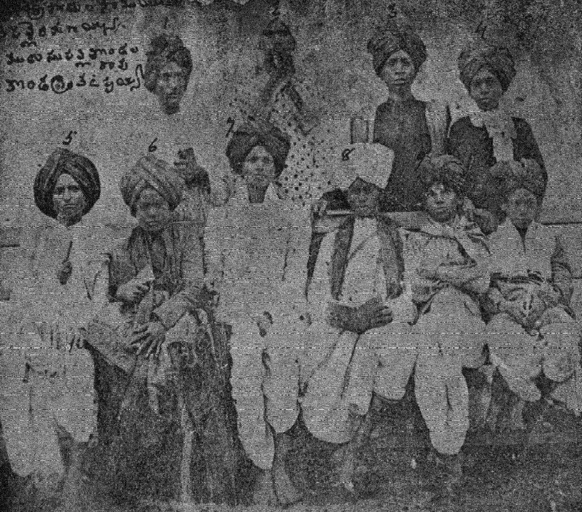 A faded halftone photograph of about ten men in turbans and long coats, some seated and some standing, with handwritten Telugu words at the top.