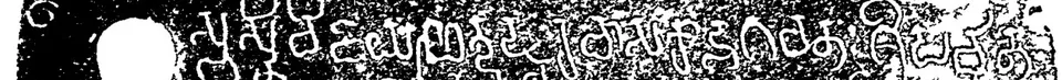 Detail of an ink impression of a copper plate: one line of white letters beside the round ring-hole.