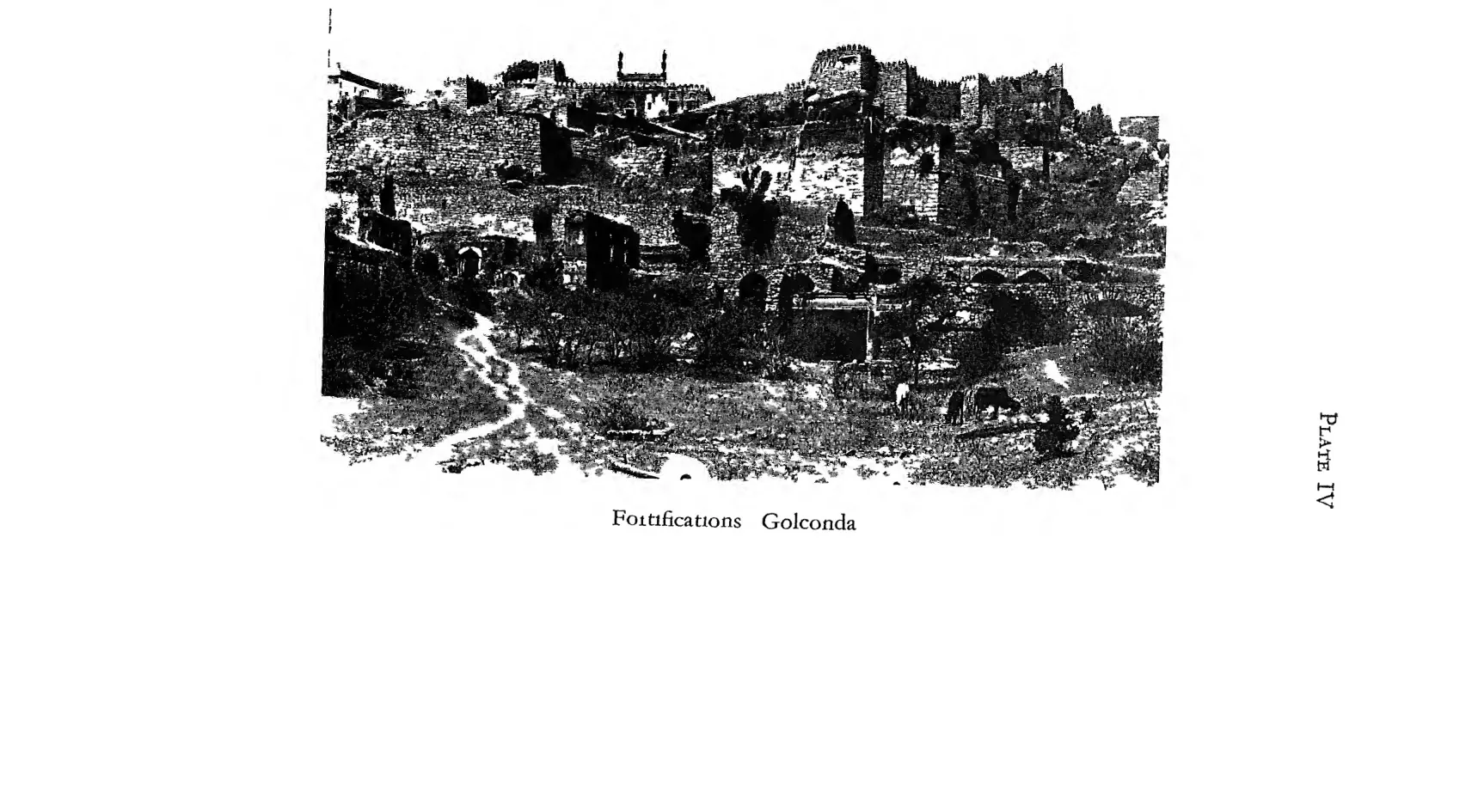 Photograph of ruined fortification walls and buildings climbing the rocky hill at Golconda.