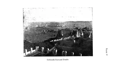 Photograph from the fort walls looking over boulders and battlements towards the plain where the tombs stand.