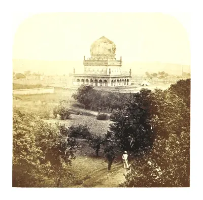Old photograph of a domed tomb on a high terrace seen over trees and bushes, with a figure standing on the path.