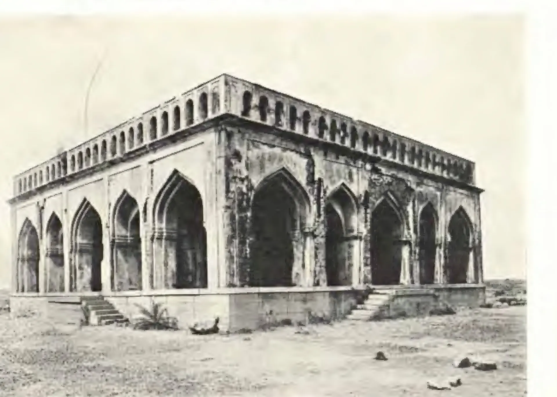 Photograph of a square pavilion with five pointed arches on each side, a carved parapet and steps up to its plinth.