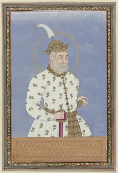 Deccani painting of a white-bearded man in a long white robe and a white turban with a plume, standing against a blue ground with a halo round his head, in a decorated border.