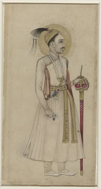 Deccani drawing, lightly coloured, of a standing man in a long white robe and plumed turban holding a sheathed sword, on a plain ground without a border.