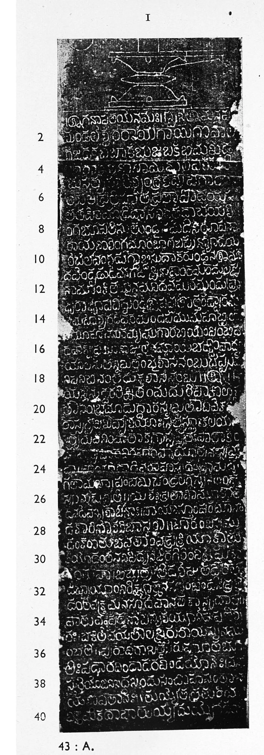 Photograph of an ink impression of a tall narrow inscribed stone face, white Telugu letters on black in close lines, a small carved emblem at the top and line numbers 2 to 40 in the left margin.