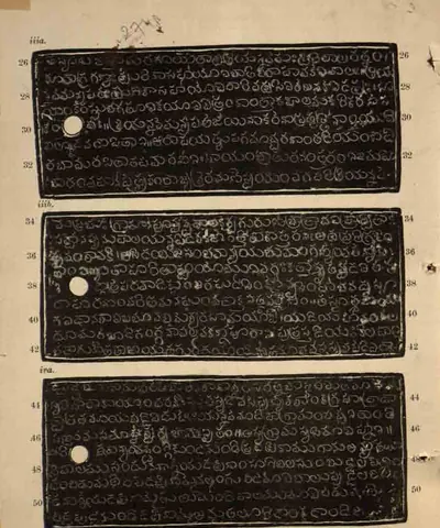 Ink impressions of three long copper-plate faces, white Telugu letters on black, each with a white ring hole at the left and line numbers 26-50, on a yellowed page with a pencilled number at the top.